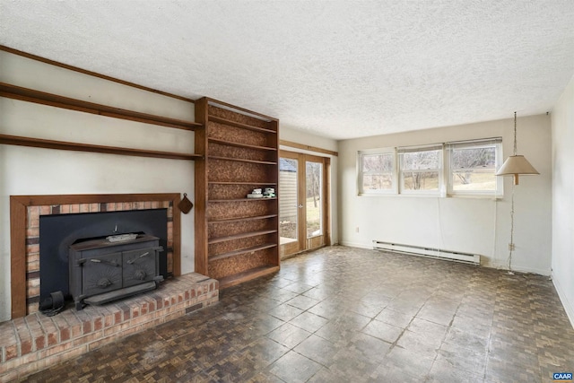 unfurnished living room with french doors, baseboard heating, a wood stove, and a textured ceiling