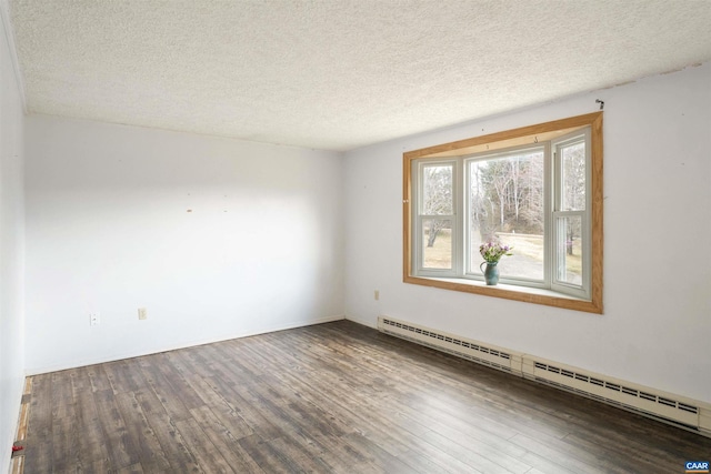 spare room with a baseboard heating unit, a textured ceiling, and wood finished floors