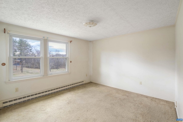 carpeted spare room featuring baseboard heating and a textured ceiling