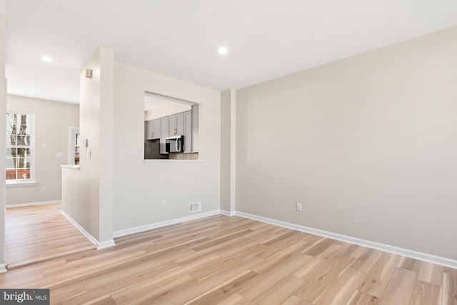 unfurnished living room with recessed lighting, visible vents, baseboards, and light wood-style floors