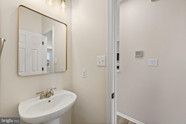 bathroom with baseboards and a sink