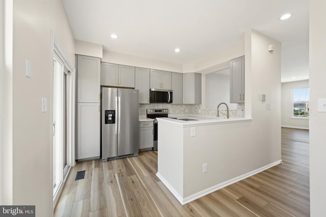 kitchen with visible vents, appliances with stainless steel finishes, and gray cabinetry