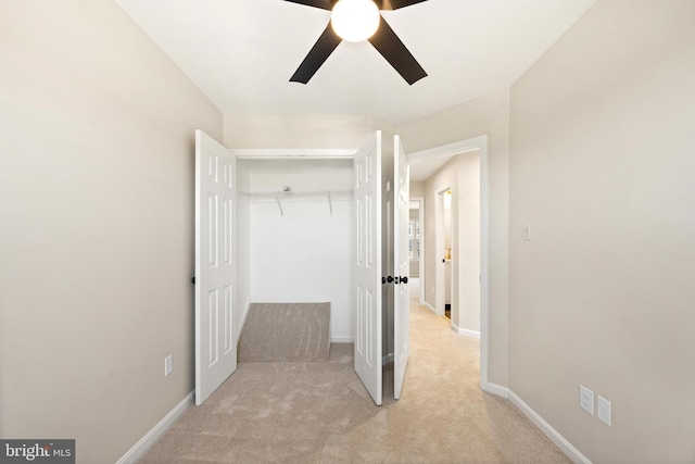 unfurnished bedroom featuring ceiling fan, carpet, a closet, and baseboards