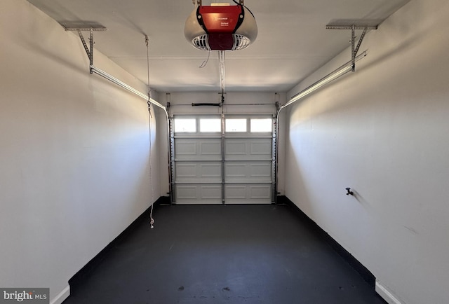 garage with a garage door opener and baseboards