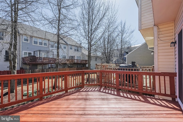 wooden deck featuring a residential view and fence