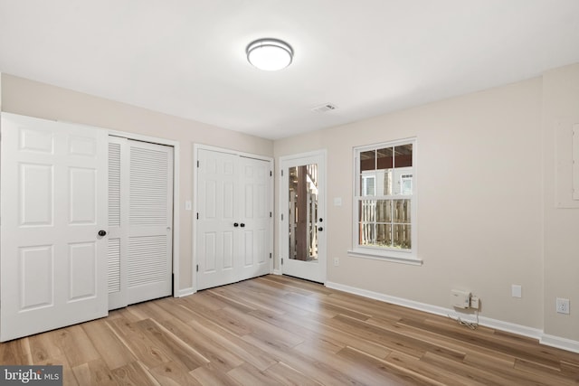 entrance foyer featuring baseboards, visible vents, and light wood finished floors