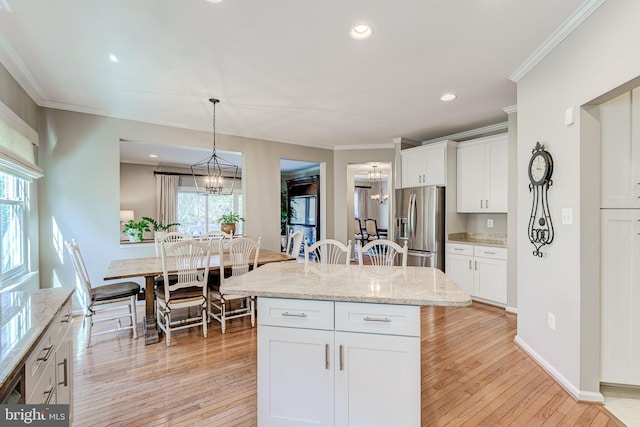 kitchen with crown molding, light wood-style flooring, a notable chandelier, and stainless steel fridge with ice dispenser