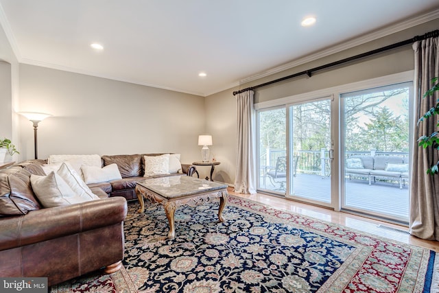 living area featuring recessed lighting, wood finished floors, visible vents, and ornamental molding