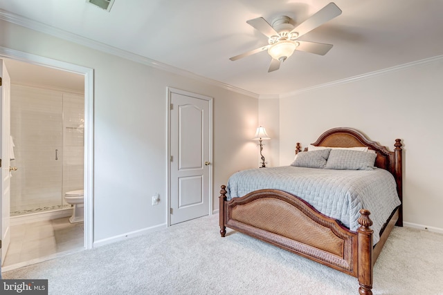 carpeted bedroom featuring a ceiling fan, baseboards, ensuite bathroom, and ornamental molding