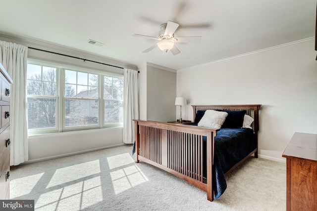 bedroom with visible vents, ceiling fan, baseboards, ornamental molding, and carpet flooring