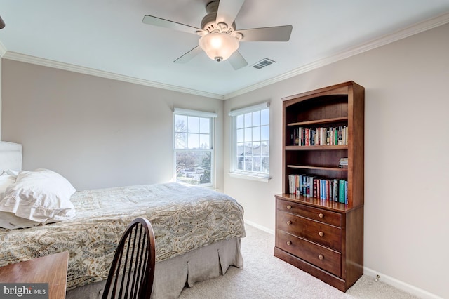 carpeted bedroom with visible vents, baseboards, and ornamental molding