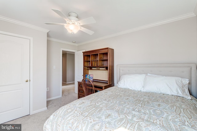 carpeted bedroom featuring baseboards, ceiling fan, and crown molding