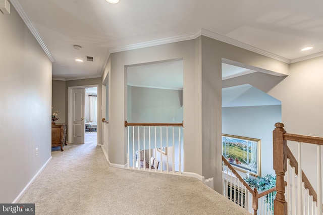 hall featuring visible vents, an upstairs landing, baseboards, and carpet flooring