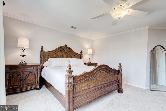 carpeted bedroom with a ceiling fan, crown molding, baseboards, and visible vents