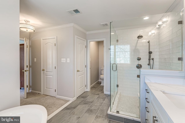 bathroom featuring visible vents, toilet, ornamental molding, and a shower stall