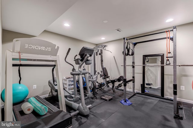 exercise area featuring recessed lighting and baseboards