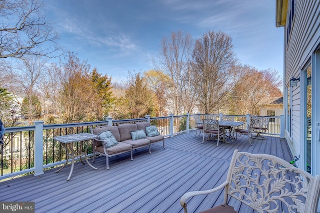 wooden deck with an outdoor living space and outdoor dining space