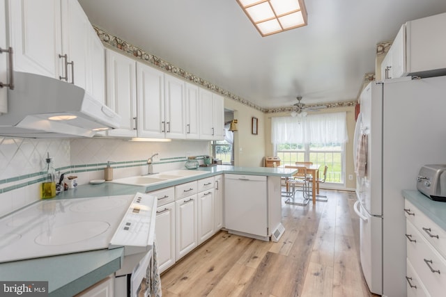 1629 Pondview Dr, Winchester, VA 22601 - kitchen with white appliances, under cabinet range hood, white cabinets, light wood-style flooring, and a peninsula