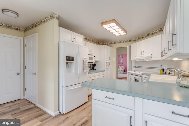1629 Pondview Dr, Winchester, VA 22601 - kitchen featuring white appliances, light wood-type flooring, a peninsula, and white cabinetry