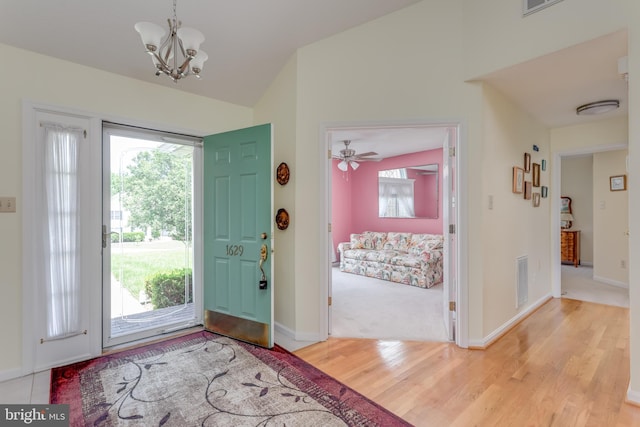 1629 Pondview Dr, Winchester, VA 22601 - foyer featuring vaulted ceiling, plenty of natural light, wood finished floors, and a chandelier