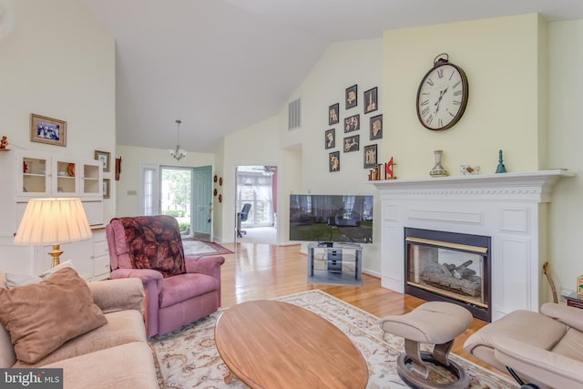 1629 Pondview Dr, Winchester, VA 22601 - living area featuring high vaulted ceiling, wood finished floors, and a glass covered fireplace