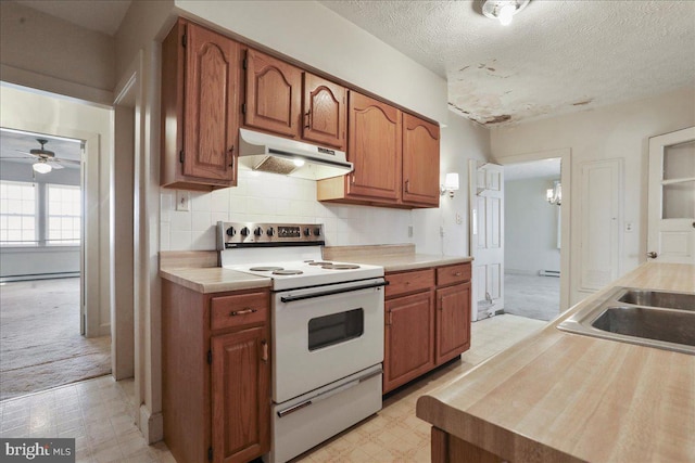 kitchen featuring light floors, ceiling fan, light countertops, under cabinet range hood, and white electric range