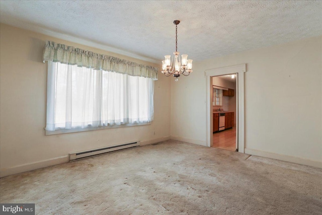 carpeted spare room with a textured ceiling, baseboards, baseboard heating, and a chandelier