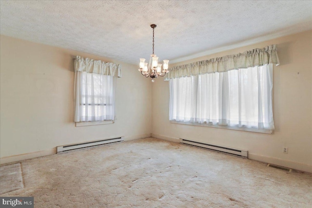 carpeted empty room with visible vents, a textured ceiling, an inviting chandelier, and a baseboard radiator