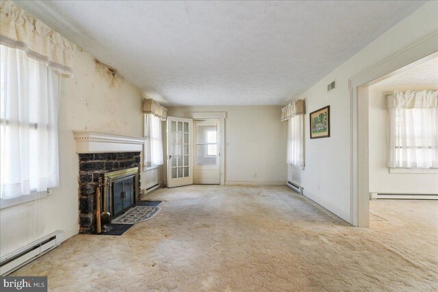 unfurnished living room with a fireplace, carpet floors, and a baseboard radiator