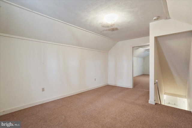 bonus room with lofted ceiling, baseboards, and carpet floors