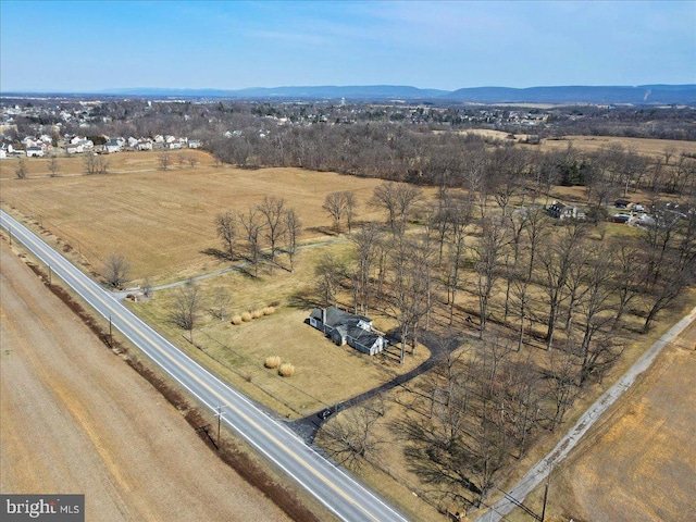 birds eye view of property with a mountain view and a rural view