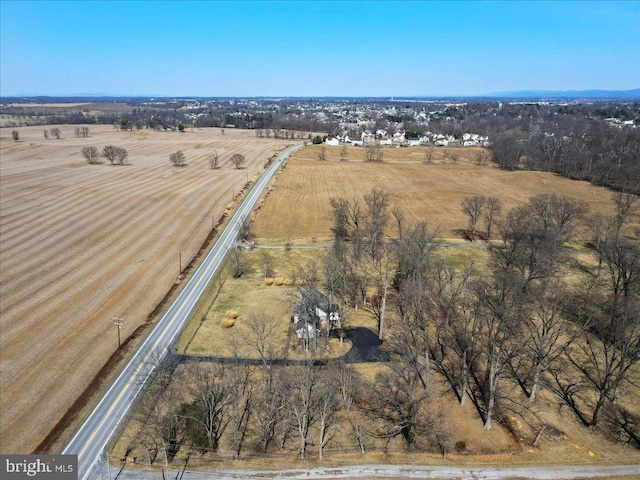 birds eye view of property with a rural view