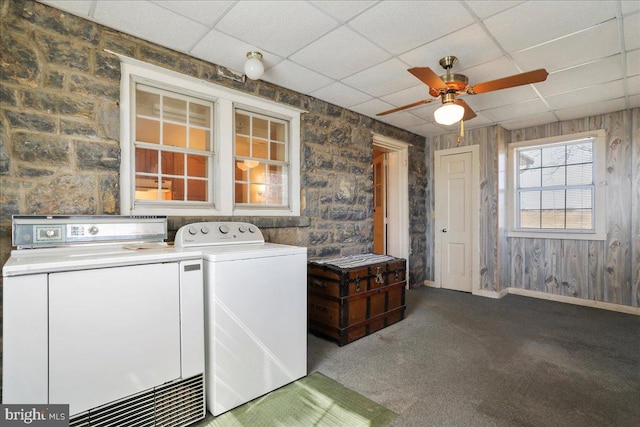 laundry room featuring baseboards, carpet, washing machine and dryer, and a ceiling fan