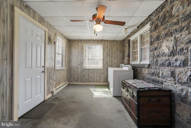 clothes washing area with a baseboard heating unit, carpet, ceiling fan, laundry area, and independent washer and dryer