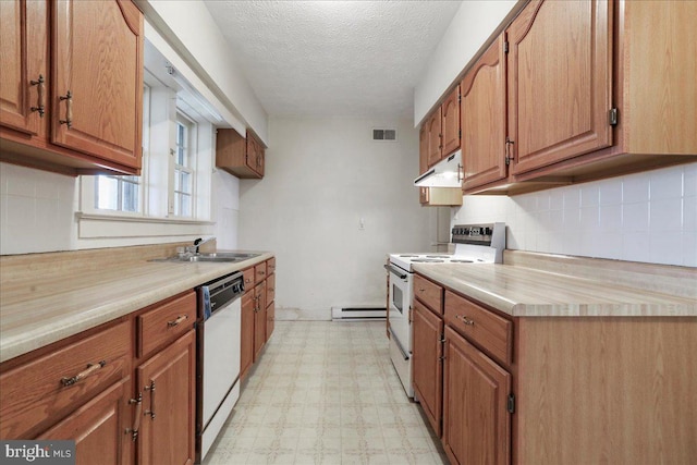 kitchen with white appliances, light floors, a sink, under cabinet range hood, and baseboard heating