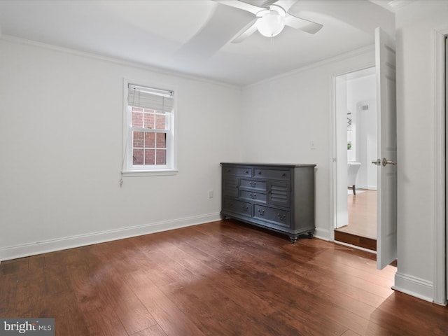 unfurnished bedroom with ornamental molding and dark wood-style flooring