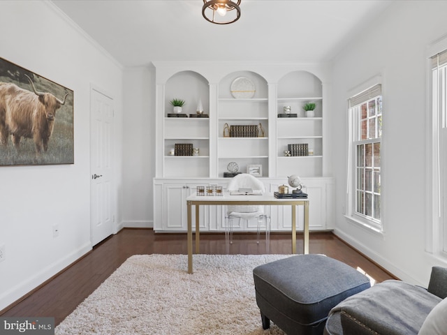 sitting room featuring baseboards, dark wood-style flooring, and ornamental molding