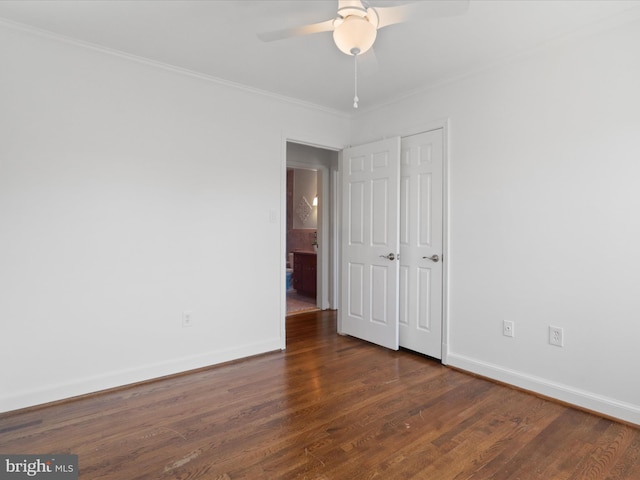 unfurnished bedroom with a ceiling fan, crown molding, baseboards, and dark wood-style flooring