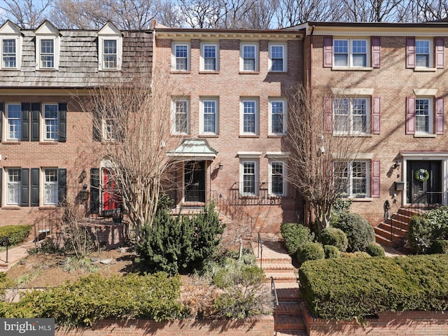 townhome / multi-family property featuring brick siding