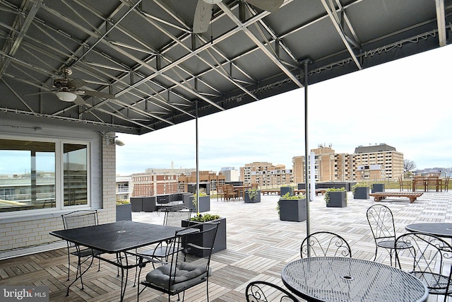 wooden deck with a view of city and outdoor dining area