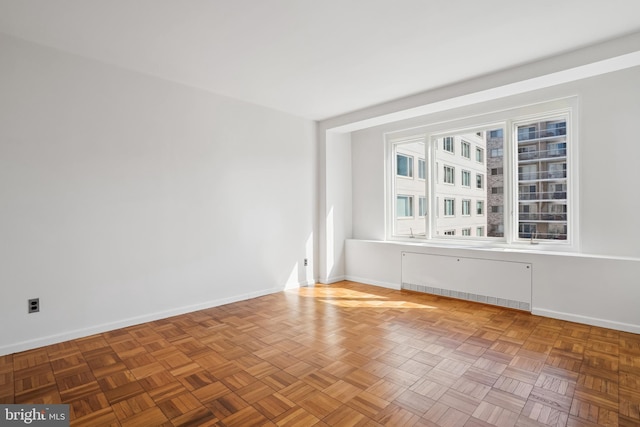 2475 Virginia Ave NW Unit 618, Washington, DC 20037 - empty room with radiator and baseboards