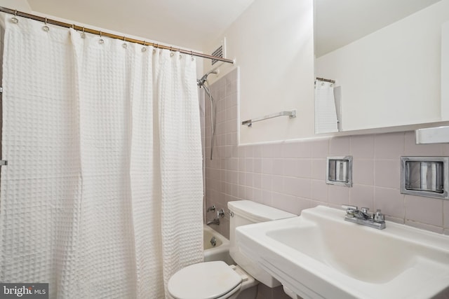 2475 Virginia Ave NW Unit 618, Washington, DC 20037 - bathroom featuring toilet, tile walls, shower / tub combo, and a sink