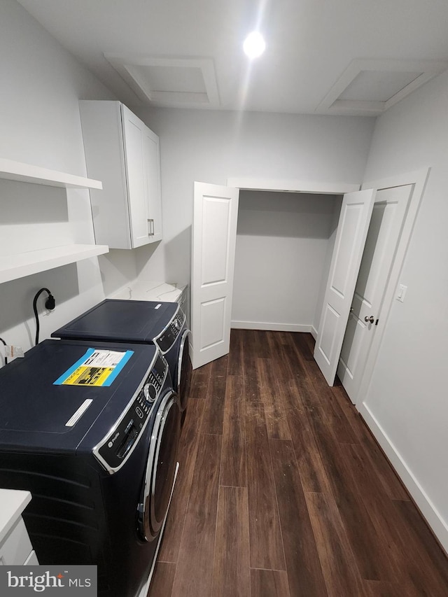 laundry room featuring baseboards, dark wood-style floors, independent washer and dryer, attic access, and cabinet space