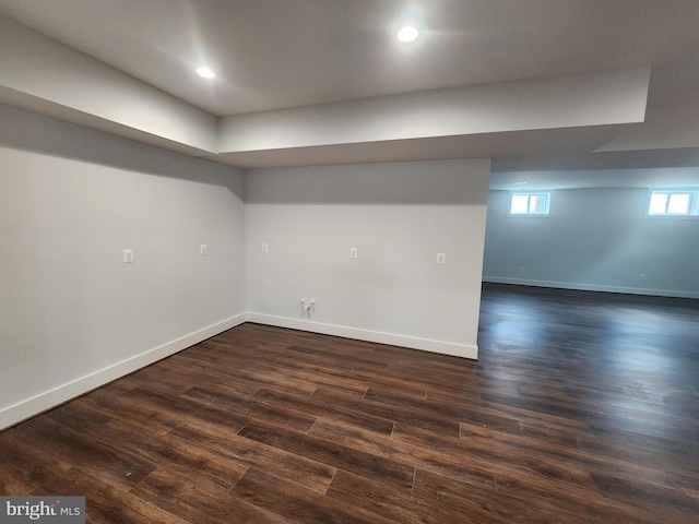 below grade area featuring baseboards, recessed lighting, and dark wood finished floors