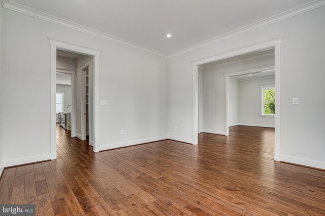 empty room with ornamental molding, baseboards, recessed lighting, and hardwood / wood-style floors