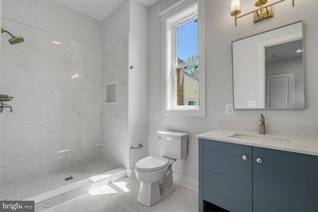 full bath featuring toilet, a tile shower, marble finish floor, and vanity