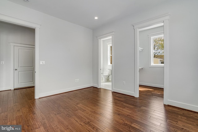 interior space featuring recessed lighting, baseboards, a spacious closet, and hardwood / wood-style flooring