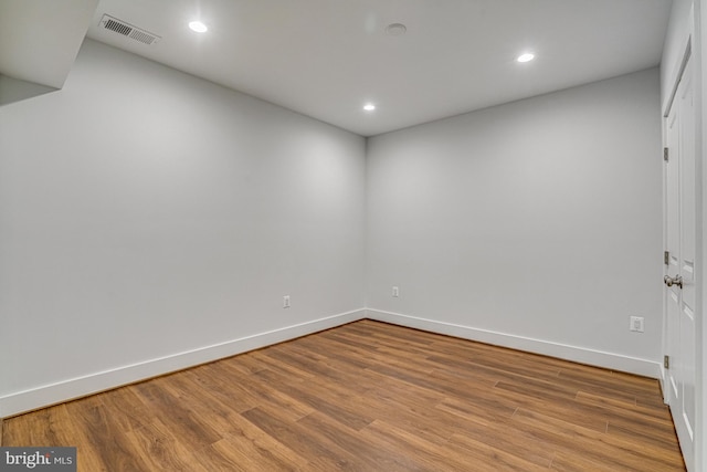 unfurnished room featuring recessed lighting, visible vents, baseboards, and wood finished floors