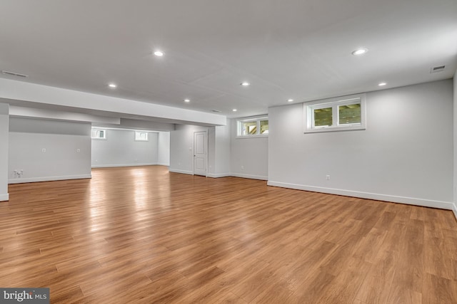 below grade area featuring recessed lighting, visible vents, and light wood-type flooring