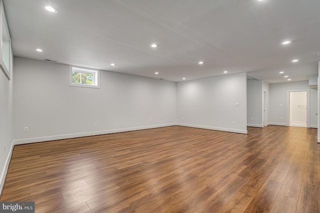 below grade area featuring wood finished floors, baseboards, and recessed lighting